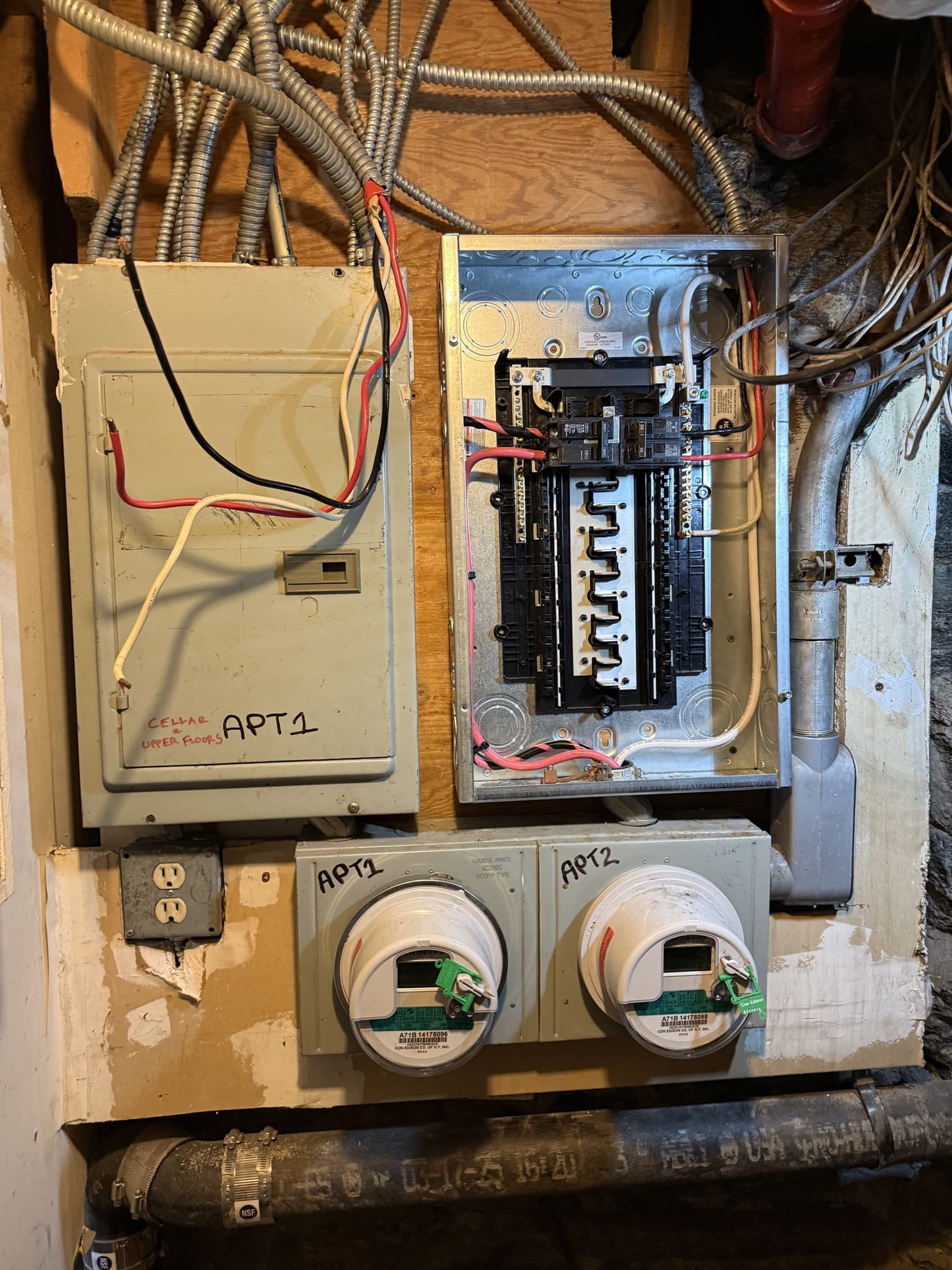 NYC residential electrical panel and dual meter upgrade mounted with organized conduit routing.