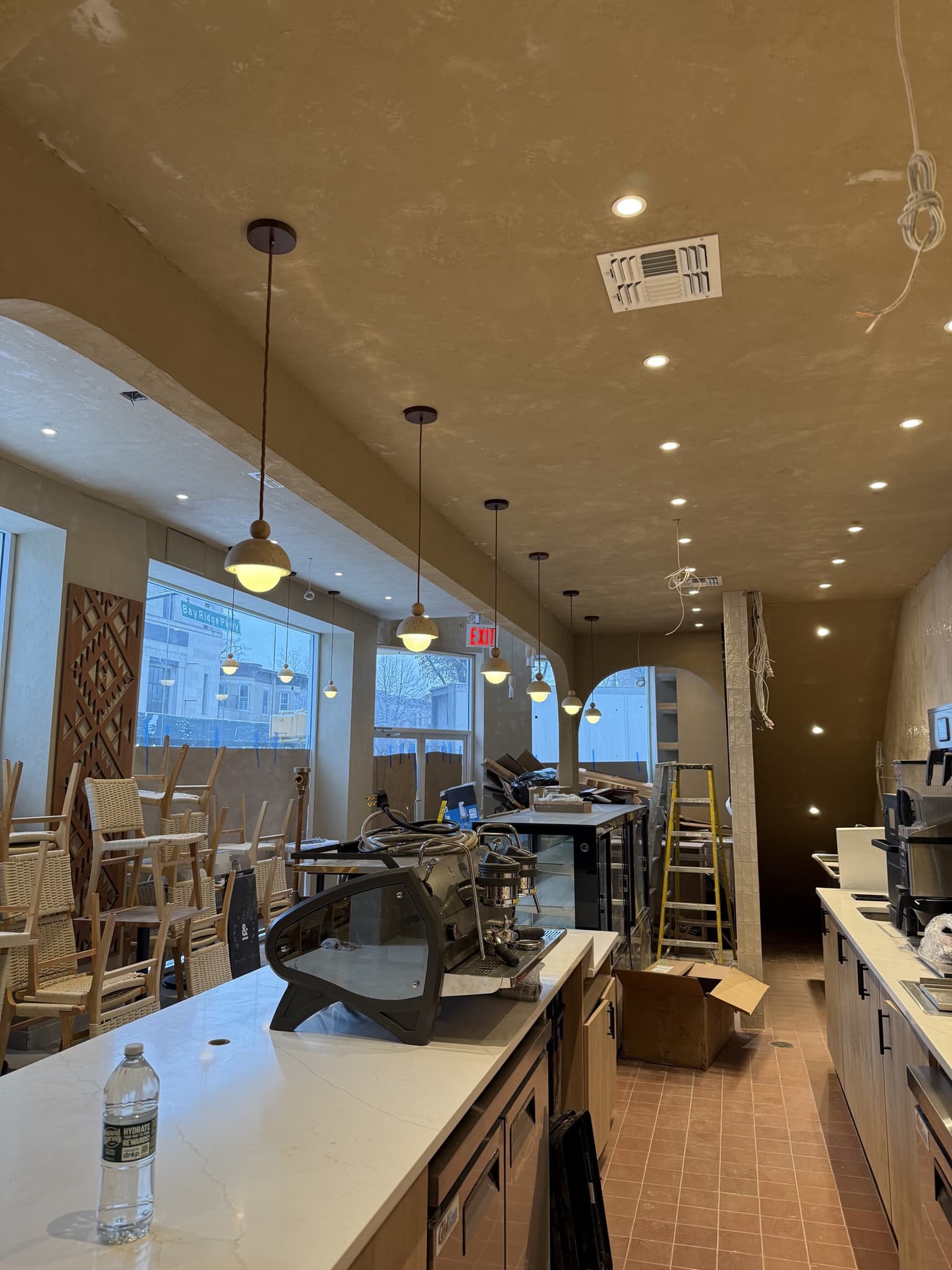 NYC hospitality interior with integrated cove lighting and architectural electrical finish details.